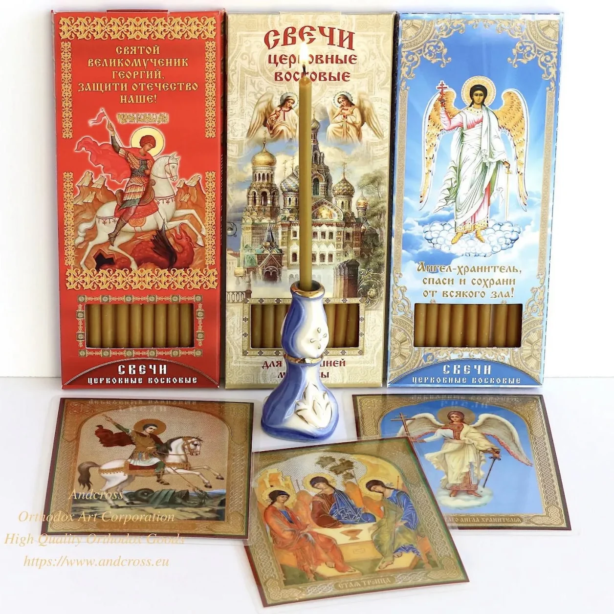 Three boxes of wax candles with a ceramic holder and icon cards