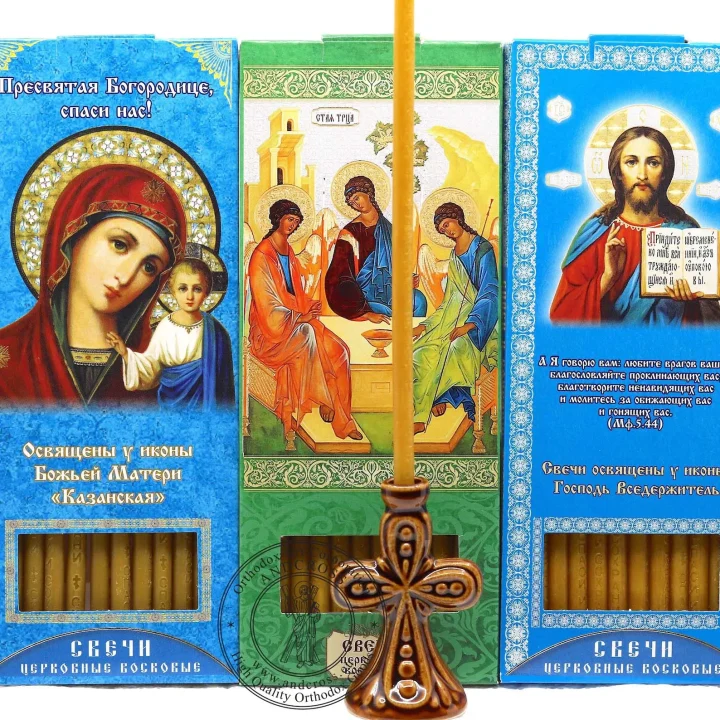 Three boxes of wax church candles with a ceramic holder