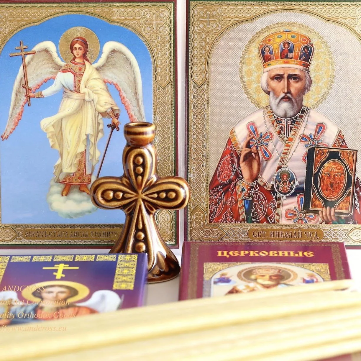 Wax church candles with a ceramic holder and icons of the Guardian Angel and St Nicholas