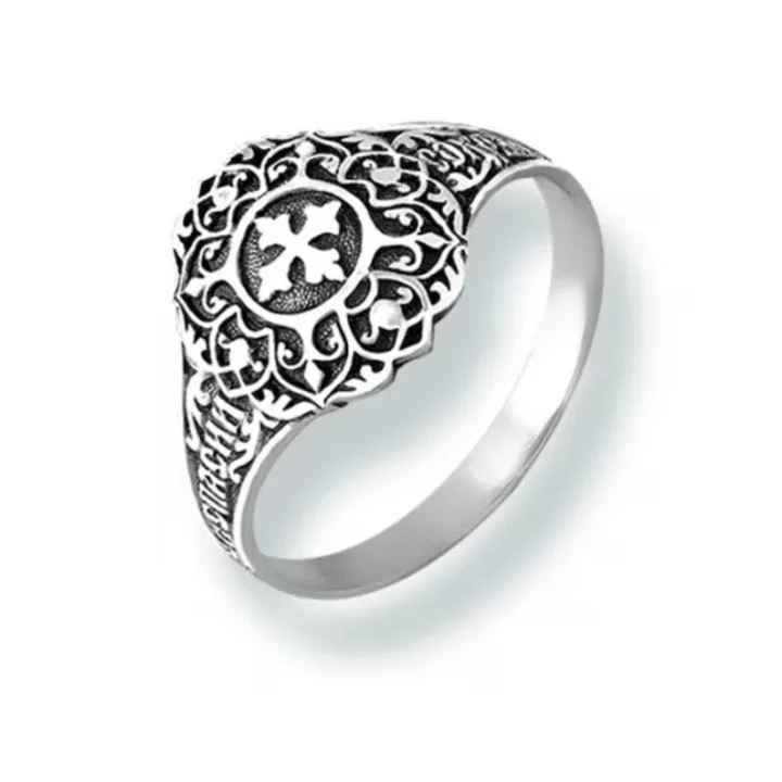 Sterling silver ring with a cross at the centre and a Christian ornament
