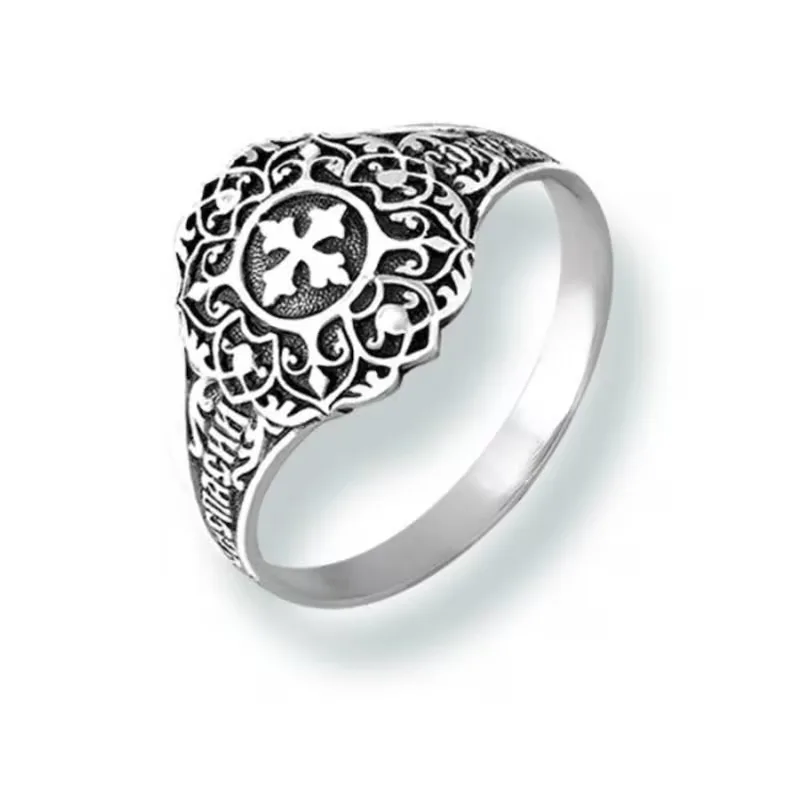 Sterling silver ring with a cross at the centre and a Christian ornament