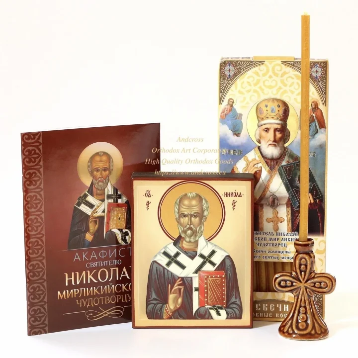 St Nicholas icon set with wax candles and a ceramic holder